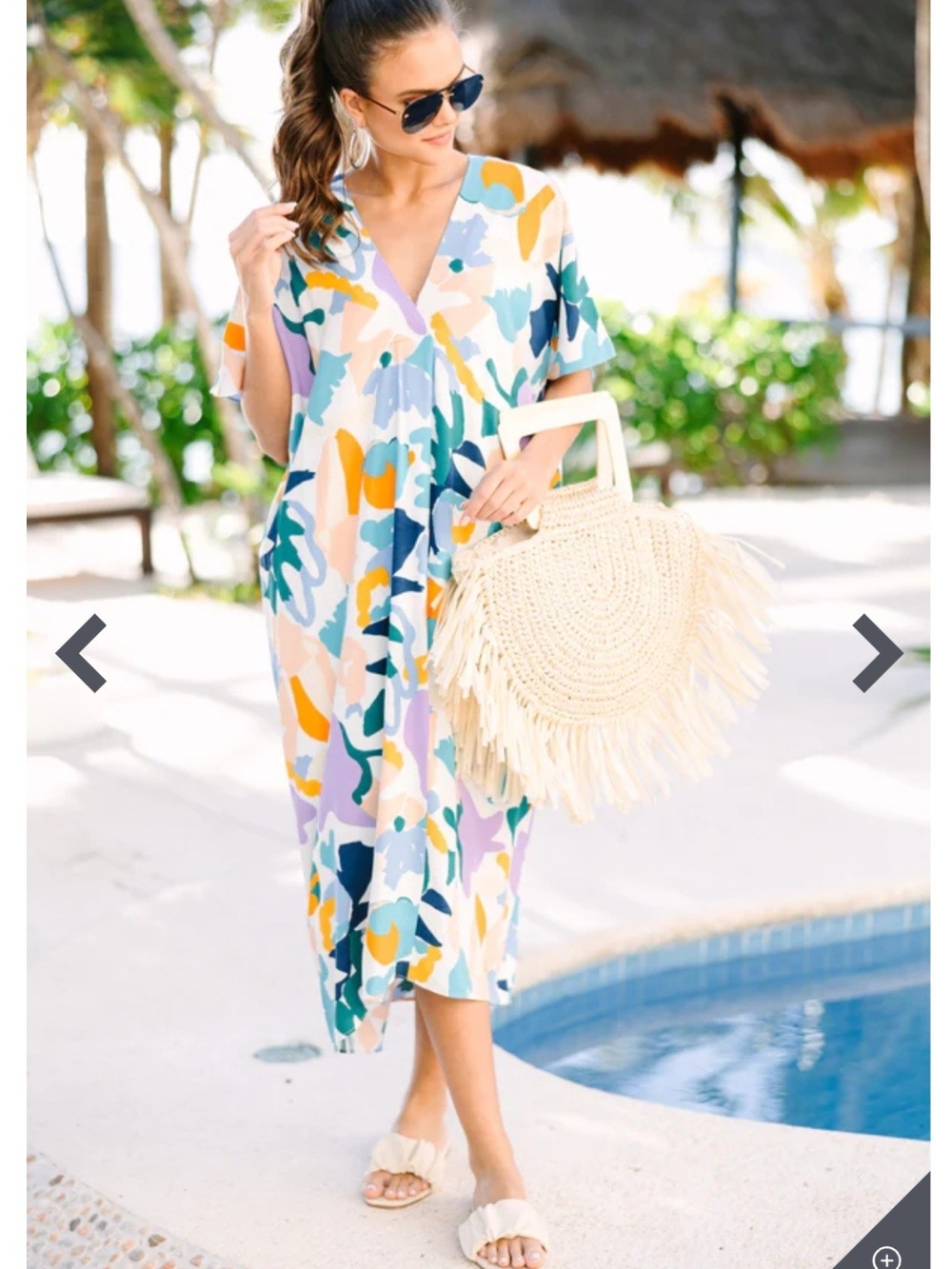 This colorful abstract midi dress by Entro Boutique features a breezy v-neckline